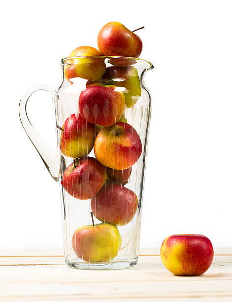 istock Ripe apples in a glass jug 511009904