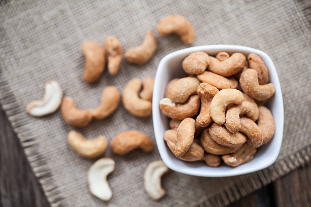 istock Salted cashew nuts in bowl on sackcloth 511010092