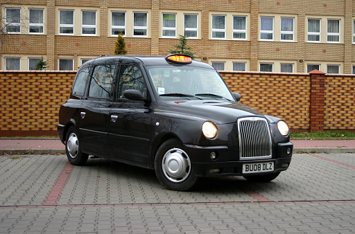 Warsaw, Poland – December 11th, 2009: LTI TX4 (London Taxi Company) taxi stopped on the street. This vehicle is equipped in special wheelchair ramp on the right side of the car. The LTI TX4 is the most popular taxi vehicle in UK.