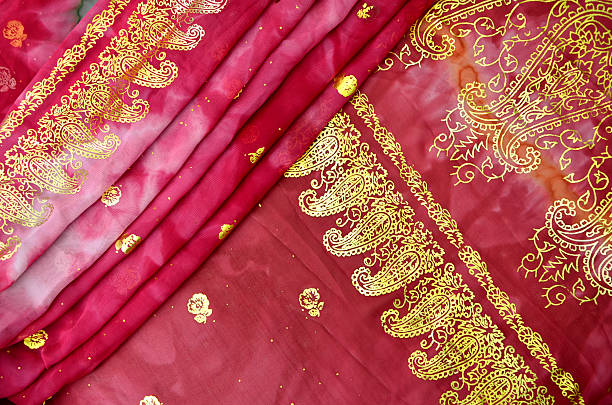 istock Folded Magenta Pink Indian Sari with Gold Paisley Pattern Border 511012274