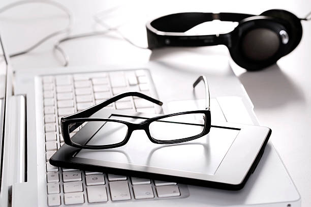 istock white laptop glasses and earphones 511013142