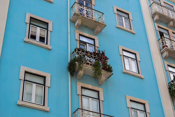 istock Blue house with several windows and flowers in the balcony 511013950