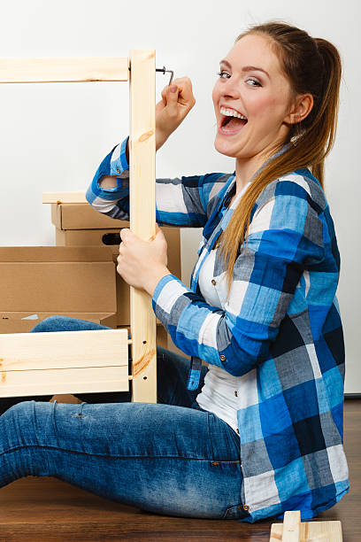 istock Woman assembling wooden furniture. DIY. 511014638