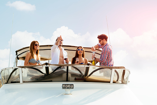 Young People Drive Yacht and having fun.