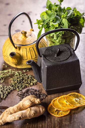 Two teapots with different tea on wooden tableTwo teapots with different tea on wooden table