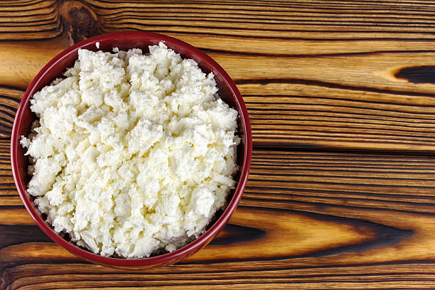 istock Fresh cottage cheese in ceramic bowl on wooden table 511017884