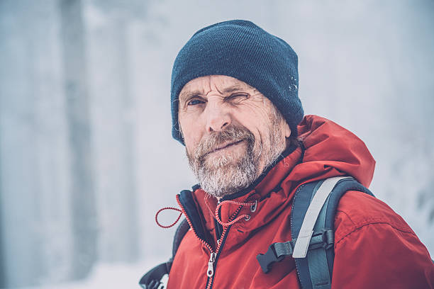istock Adventurous Senior Man Winking in Forest, Snowing, Julian Alps, Europe 511018454