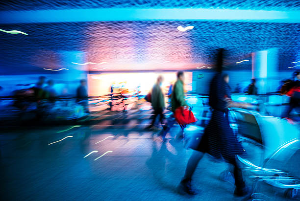 istock Motion-blurred abstract people walking to the airport terminal 511019012