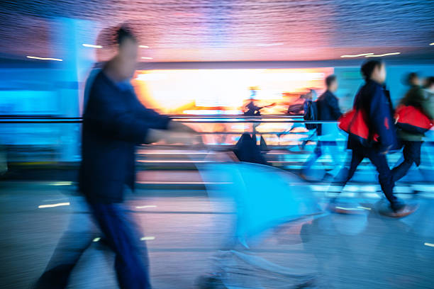 istock Motion-blurred abstract people walking to the airport terminal 511019074