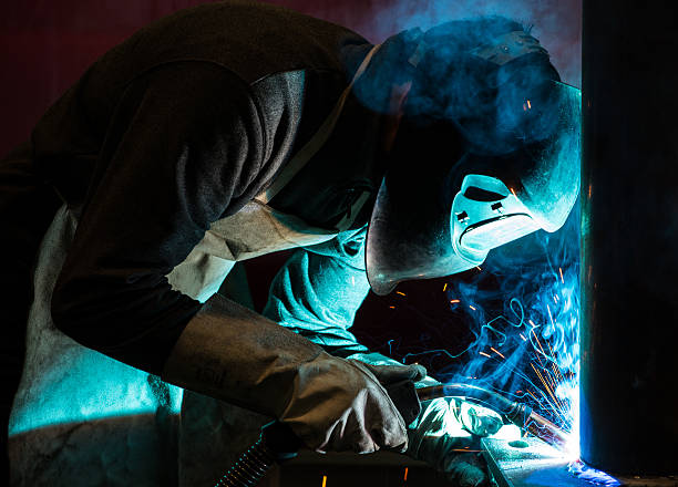 Man welding aluminium in factory stock photo