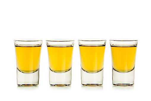 four whiskey shots isolated on white