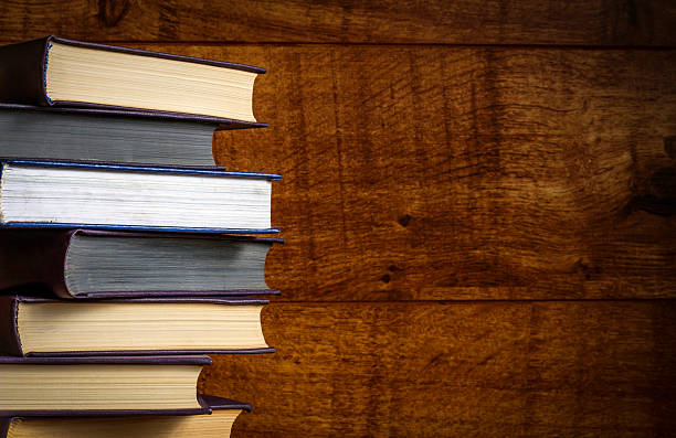 istock Old book on wooden background 511020330