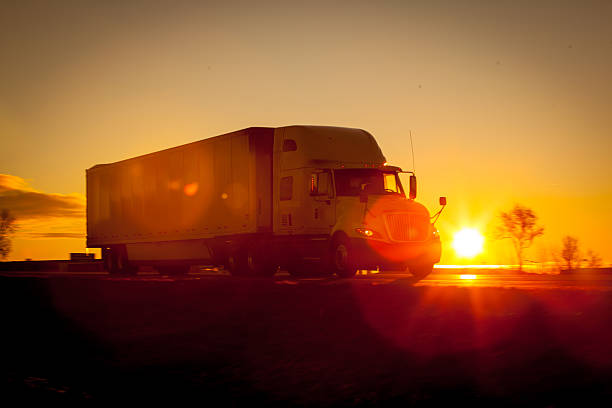 istock Tractor trailer driving down the highway at sunrise. 511021536