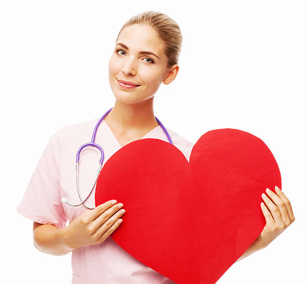 istock Smiling Nurse Holding Heart Shape 511021992