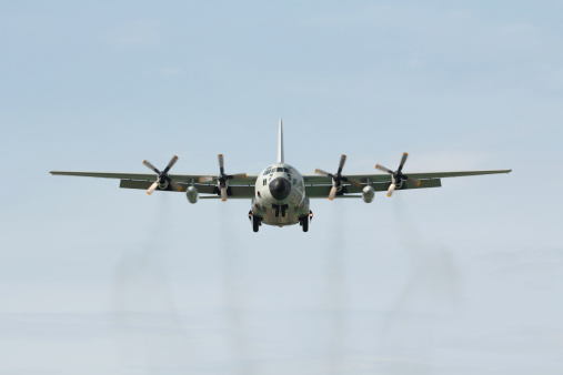 The military airplane (C-130) head on landing