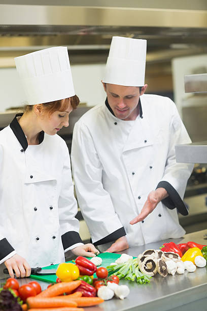 istock Smiling chef looking at his colleagues sliced mushrooms 511024867