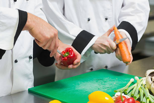 istock Close up of two chefs cutting vegetables 511024871