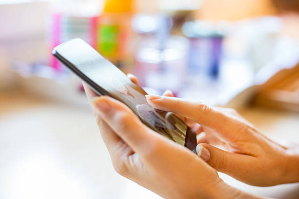 istock Woman consults her cell phone, home 511024968