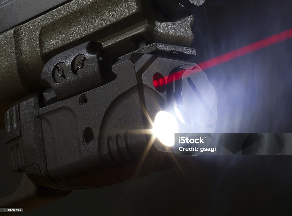 Laser aiming on a handgun Laser and flashlight mounted on the bottom of a pistol Flashlight Stock Photo