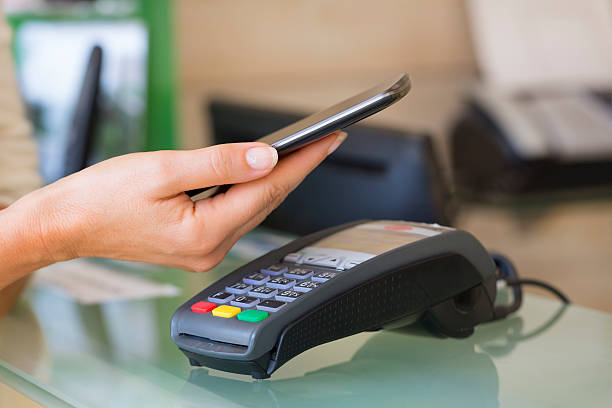 istock Woman paying with NFC technology on mobile phone, beautician, 511025530