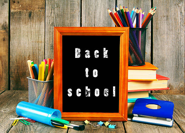 istock Books and school tools on wooden background. 511025965