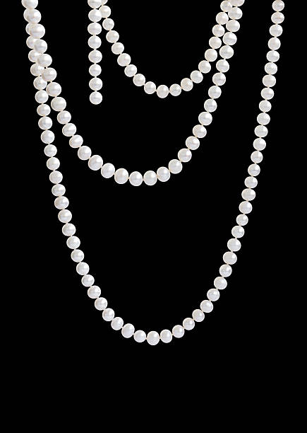 Hanging natural pearl necklace, isolated on black
