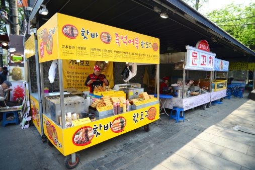 Seoul, South Korea - April 13, 2014: Unidentified Korean man sells traditional street food i.e. fish ball stick at Insadong market, Seoul in South Korea.