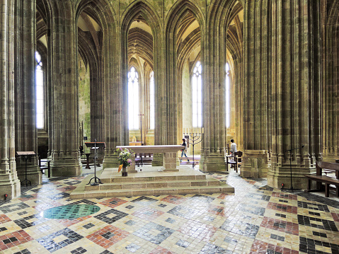 Mont Saint-Michel, France - August 9, 2014: people in Interior of Church-abbey Mont Saint Michel. The abbey has been protected as a French monument historique from 1862