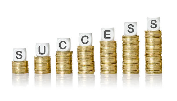 istock Coin stacks with letter dice - Success 511028014