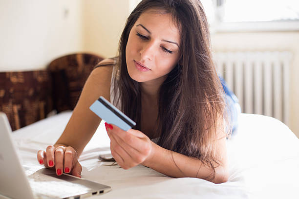 istock Young beautiful woman shopping using laptop 511028180