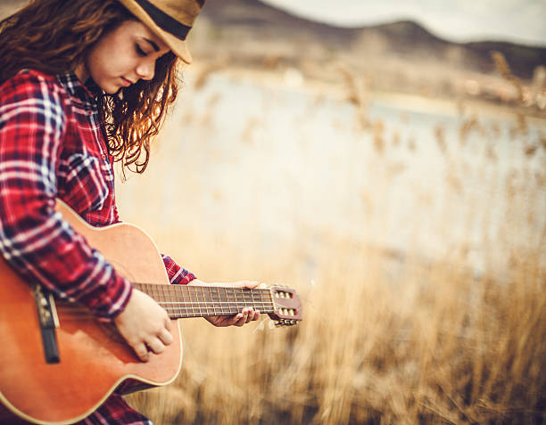 istock young women with guitar 511029824
