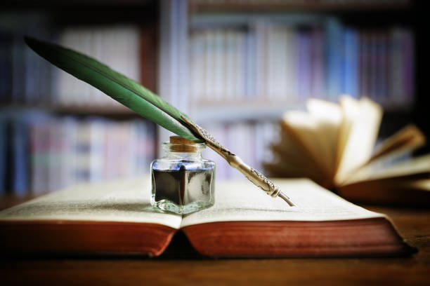 istock Quill pen on an old book in a library 511030022
