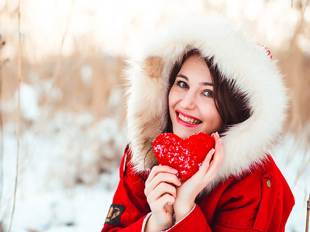 istock Winter nice girl holding a red heart 511032504