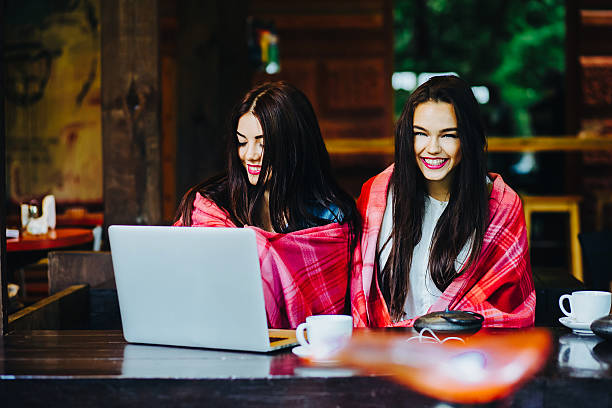 istock two girls watching something in laptop 511032680
