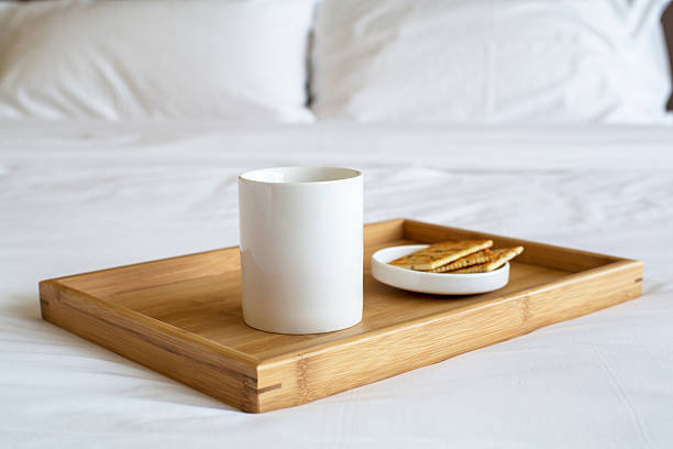 porcelain cup and biscuit on bed