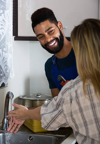 istock plumber and housewife in kitchen 511053780