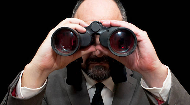 istock Handsome business man, bald and bearad, looking through binoculars 511054004