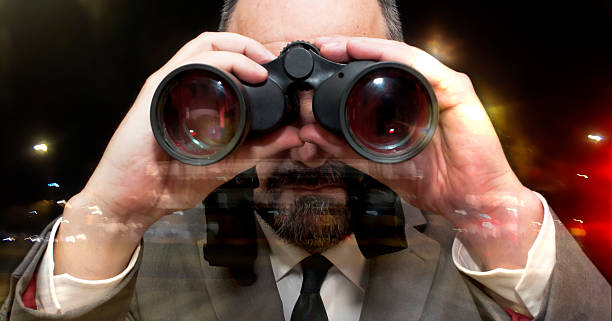 istock Handsome business man, bald and bearad, looking through binoculars 511054034