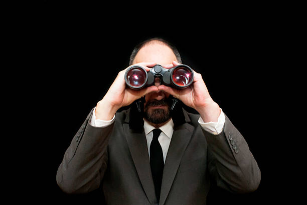 istock Handsome business man, bald and bearad, looking through binoculars 511054222