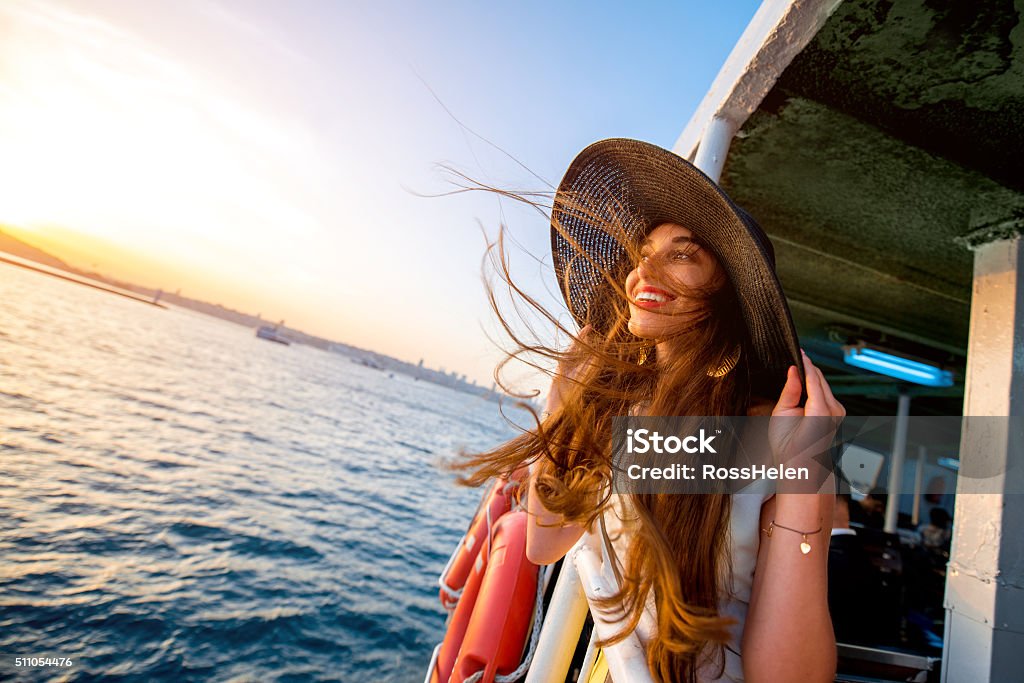 Woman enjoying the sea from ferry boat Happy woman enjoying the sea from ferry boat crossing Bosphorus in Istanbul Tourist Stock Photo