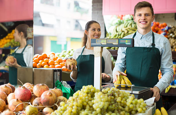 istock Sellers offering bananas at market 511054584