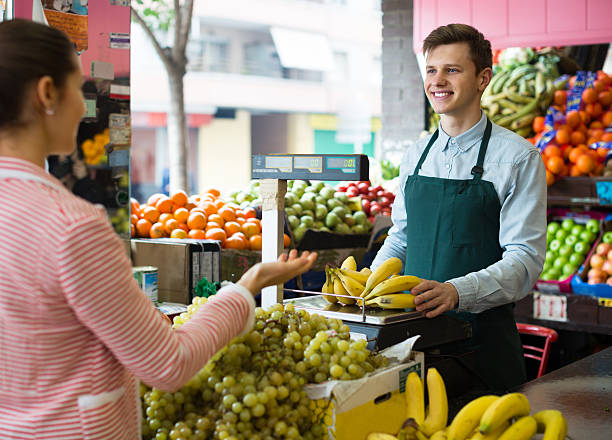 istock seller weighing bananas 511054610