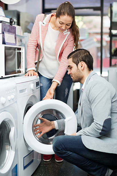 istock Young couple choosing washing machine 511055332