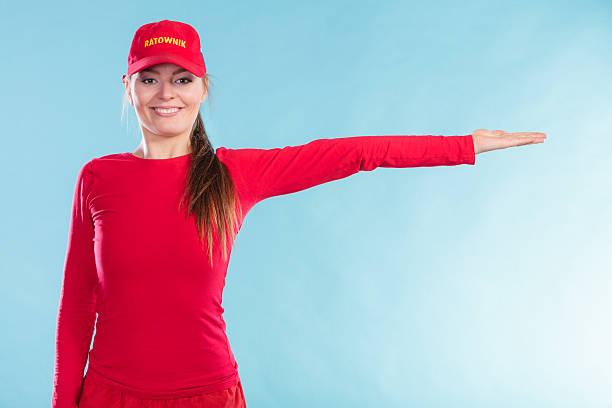 istock Happy lifeguard woman in cap pointing direction. 511057792