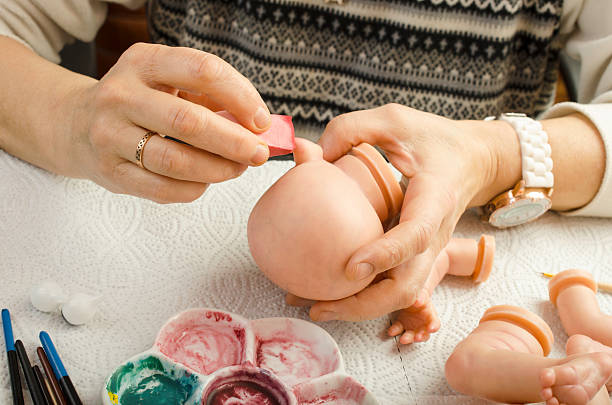 istock Hand painted reborn dolls. Application of lacquer on head. 511059114