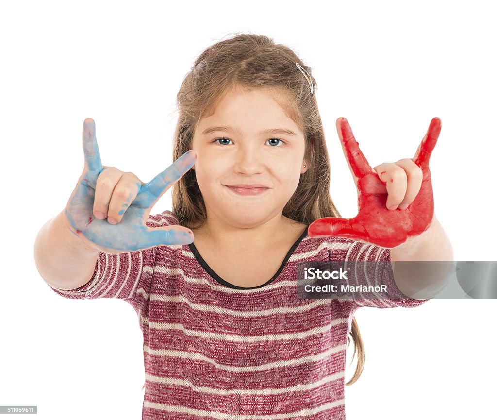 Little Girl Playing with Paint doing the horns. Cute little girl playing with red and blue paint showing her fingers. Beautiful People Stock Photo