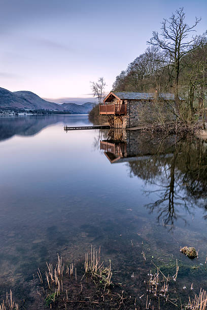 istock Morning Light Shining On Boathouse With Clear Reflections In Lake. 511059898
