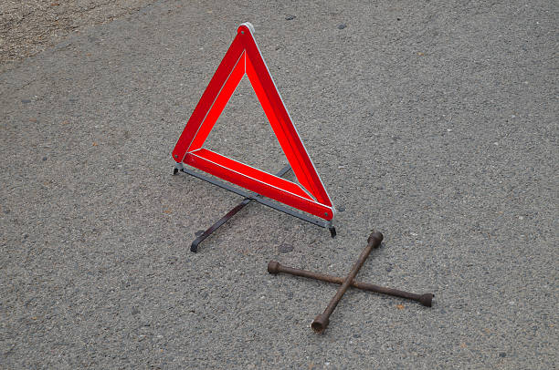 istock Reflective car warning triangle on the road 511060240