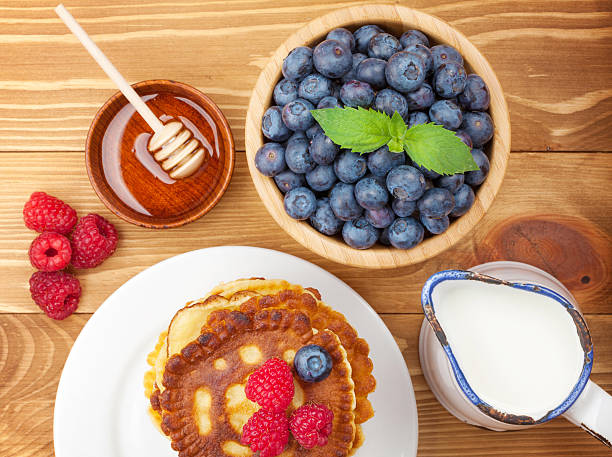 Pancakes with raspberry, blueberry, milk and honey syrup
