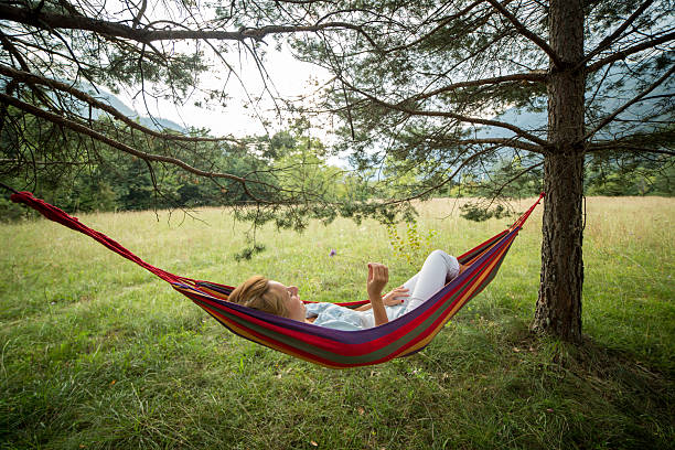 istock Woman relaxing on hammock in nture 511060415